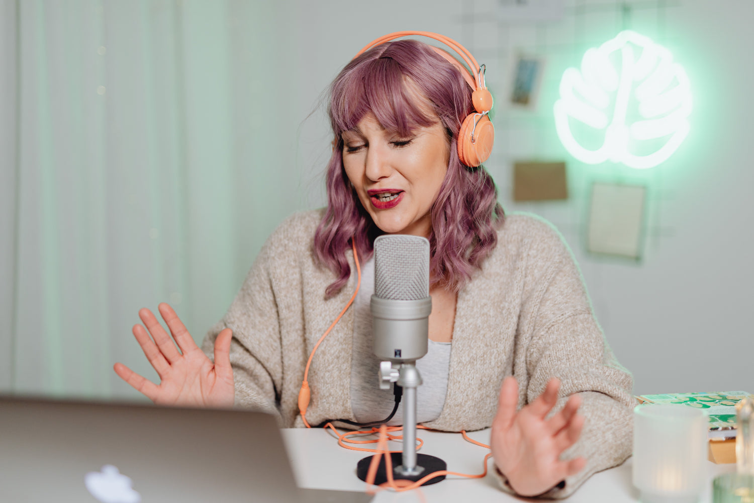 Woman recording a podcast with a microphone and headphones